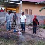 Marselinus Pasapan Anggota DPRD Kota Palu Menyerahkan Bantuan Sumur Bor
